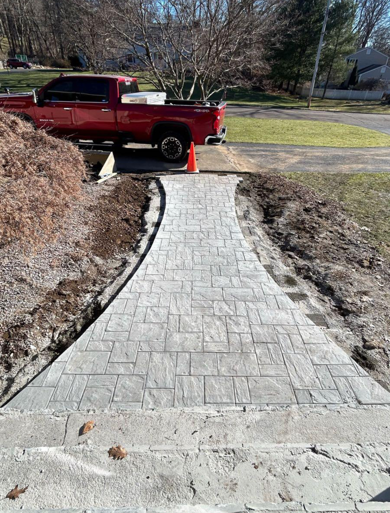 Stamped paver walkway installation from street to residential home